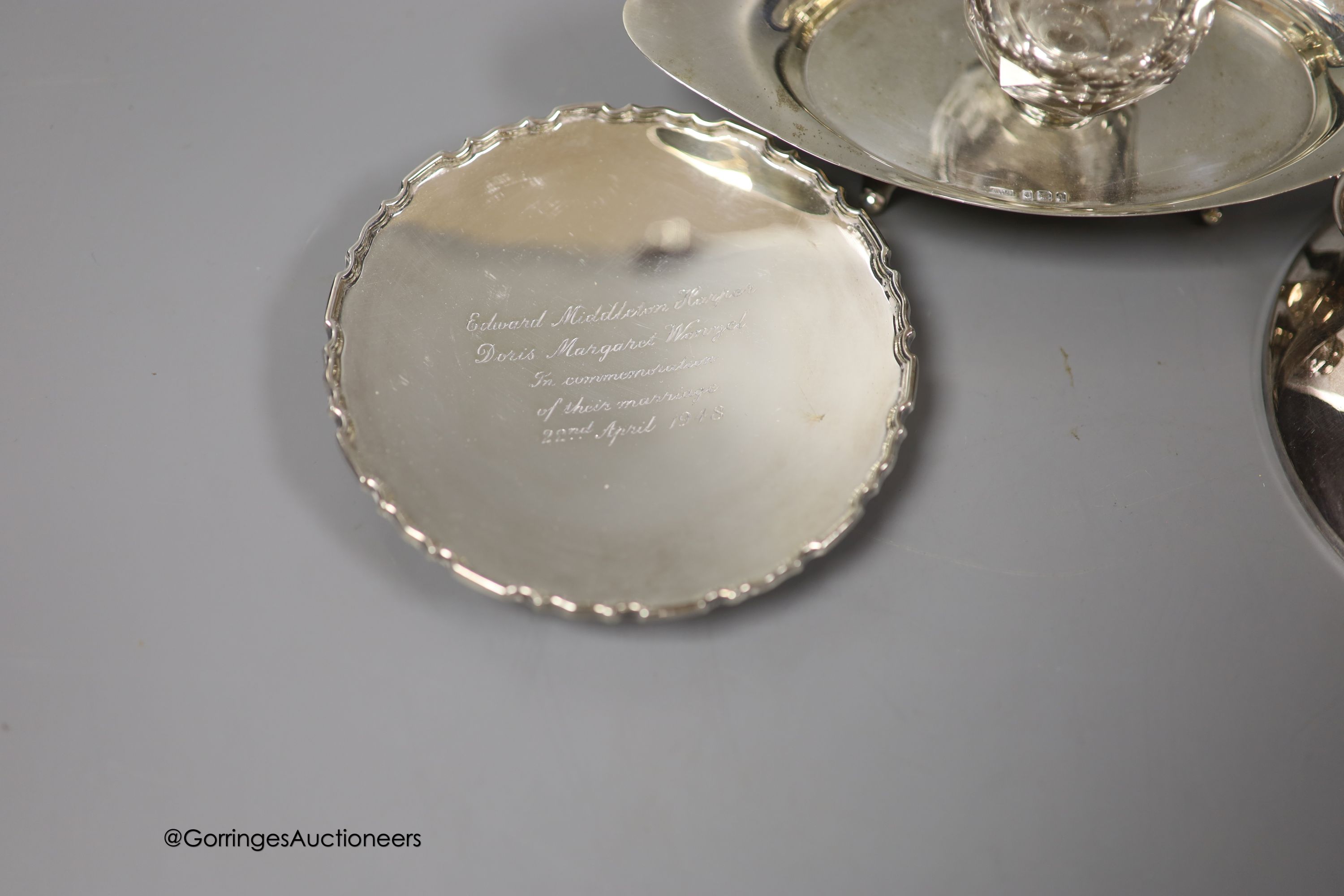 An Edwardian silver navette shaped inkstand, with single well, Birmingham, 1903, 17.5cm, a small modern silver presentation dish and an early 20th century German 835s white metal mounted chamberstick, by Gayer & Krauss.